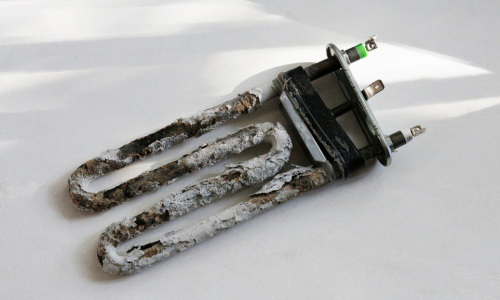 A heating element covered in limescale.